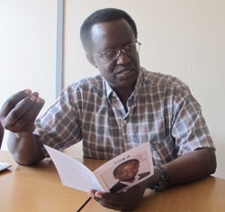 Senatorial aspirant Prof. Kananga Simba Ntale makes a point at The New Times offices yesterday as he holds a copy of his manifesto. The New Times /Doreen Umutesi.