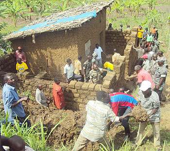 RDF personnel join residents to put up houses for vulnerable residents. The New Times /File