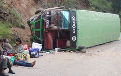 Survivors of the accident wait for another bus after the accident, yesterday. Photo The New Times /Fred Ndoli