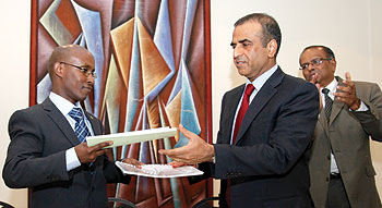 ICT Minister Ignace Gatare (L) exchanges documents with Mr. Sunil Bharti Mittal, chairman and director of Bharti Artel.The New Times / Timothy Kisambira