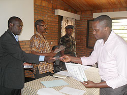 L-R-Dr Gaspard Rwanyiziri the CGIS Director, Vice Rector of NUR, Prof Musahara Herman and Lt Col Emmanuel Gashayija of the RDF Airforce Unit hands over a certificate to a participant. The New Time /Courtesy