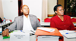 Alphonse Kalinganire, the Capacity Building Fund Coordinator (L) together with Angelina Muganza, Executive Secretary of Public Service Commission. The New Times /Timothy Kisambira