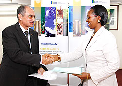  State Minister Eng. Coletha Ruhamya (R) and Mohamed Safeyeldin from ORASCOM exchange documents after the signing ceremony yesterday. The New Times /Timothy Kisambira