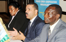 Interpol Chief Ronald Noble (C) franked by Elizabeth Kutesa(L) and Awad Dahia addressing the press yesterday. The New Times /John Mbanda.