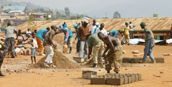  Residents prepare bricks for the construction of 9YBE classrooms. Their participation will again be required for the 12BE classes. The New Times /File.