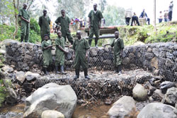 Veterans stand near one of the gabions constructed along Rwebeya water stream.The New Times / B Mukombozi