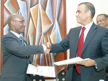 ICT Minister, Ignace Gatare, and Sunil Bharti Mittal, Bharti Airtelu2019s Chairman and Managing Director exchange documents after signing the deal that paved way for the official entry of Airtel slated for early next year. The New Times/T. Kisambira