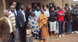 Some Huye district  officials pose for a group photo with the beneficiaries of the houses. The New Times /JP Bucyensenge.