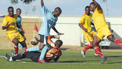 Police's Meddie Kagere fights for the ball with Etincelles goalkeeper during last season's Primus League. The New Times / File