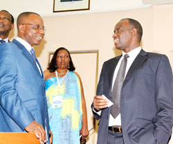 Senate vice president, Prosper Higiro (R), talks to Bienvenu Ewoko, a senator from the Democratic Republic of Congo, as Madeleine Nirere (back) looks on, during the African Parliamentary Staff meeting at the Parliament Buildings, yesterday. The New Times/