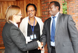 The Permanent Secretary in the Ministry of Health,  Dr. Uzziel Ndagijimana (R) talks to Christel Vermeersch from World Bank as Yvonne Kayiteshonga, in charge of mental health at MoH, looks on during the meeting to assess the impact of Performance Based Fi