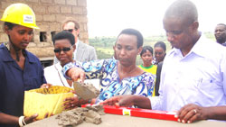 Gender Minister Aloysia Inymba lays a foundation stone for the construction of the Women Opportunity Centre in Kayonza as mayor John Mugabo (R) looks on. The New Times  / S Rwembeho