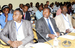 Health ministry PS Dr. Uzziel Ndagijimana (C) and other participants follow a presentation during a past performance based financing meeting. The New Times /File.