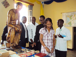 Father Pierre Celestine Rwirangira (2nd left) guides GSOB alumni through historical artefacts and archives of the school. The  New Times / Daniel Sabiiti.