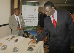 Natural resources Minister Stanilas Kamanzi examines stones mined in Rwanda. A mining giant has expressed interest in Rwandan gold. The New Times /File.