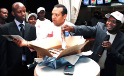 SWAHAP East Africa Region Coordinator, Daniel Mwaura, (R) together with Tigou2019s acting CEO, Diego Camberos, and (L) distribute HIV Booklets. The New Times Timothy Kisambira