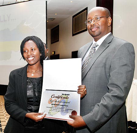 James Musoni (R)  hands a certificate to Kicukiro District Vice Mayor Angelique Mukunde after the completion of the leadership course.The New Times /Timothy Kisambira