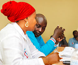 (R-L) Paul Jules Ndamage, the RPF district chairperson chats with Zulfat Mukarubega the vice chairperson of the party during the meeting, yesterday. The New Times Timothy Kisambira
