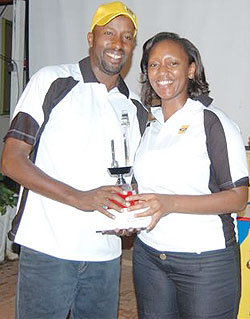 MTN's chief Marketing Officer Yvonne Makolo (R) giving Francois Rugomboka his prize.(Photo A.Numa).