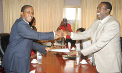  Dr Biruta (L) hands over to his successor Dr  Ntawukuliryayo at the Parliament Buildings yesterday. The New Times / John Mbanda.
