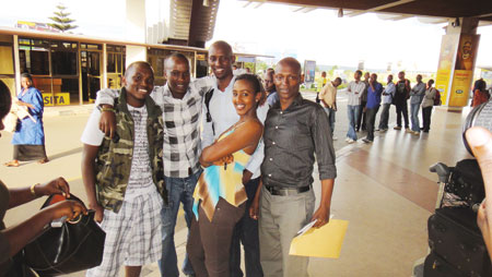 Tom Close (L) poses with friends at Kigali International Airport. The New Times/Courtesy.
