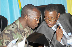  Defence Minister Gen. James Kabarebe (R) consults Lt. Col. Dr. Jean Paul Bitega in Parliament on Thursday. The New Times/ John Mbanda.
