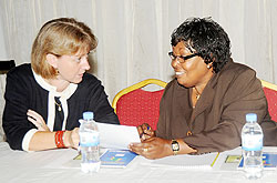  GMO Executive Secretary Aquiline Niwemfura (R) with Cynthia Caron a senior research and evaluation manager at the workshop yesterday. The New Times /John Mbanda