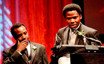 Rwandan actor Edourd Bamporiki speaks at the gala night of Heartland Film Festival in Indianapolis, USA. Looking on is Alrick Brown, the Director and Writer of the Kinyarwanda . Net photo