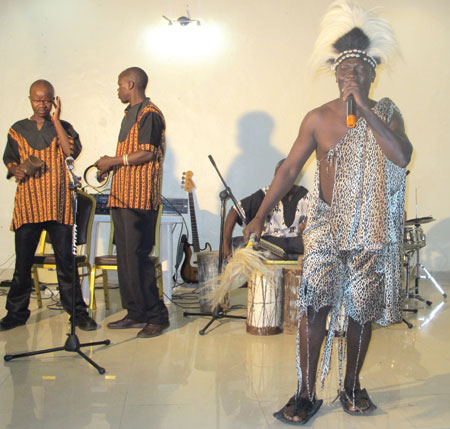 Tony Nyadundo performs in stylish Kenyan traditional attire. 