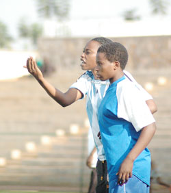 AS Kigali coach Grace Nyinawumuntu passing on tips to her players. AS Kigali lifted their third league title last season. The New Times / File.