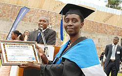  An SFB graduate displays a certificate of outstanding performance. Students at the school have said the new system remains a stumbling block. The New Times/File photo.
