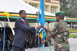 Defence Minister James Kabarebe receives the EAC flag from Lt Gen Ceaser Kayizari at the end of the EAC Command Post Exercise yesterday. The New Times / Bonny Mukombozi