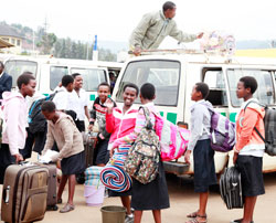 Students coming back from school yesterday. They have welcomed the new initiative of going back home in shifts. The New Times / Timothy Kisambira
