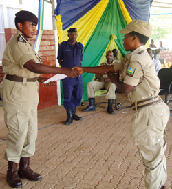 The Deputy Commissioner General of RCS, Mary Gahonzire (L), handing a certificate to one of the trainees at the end of the workshop. The Sunday Times / Stevenson Mugisha