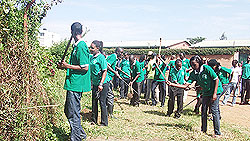 Students from Kampala University take part in community work last Saturday. The New Times / Grace Mugoya.
