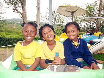 Children riding on a toy helicopter.