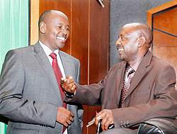 Local Government Minister James Musoni (L)chats with Hon Abbas Mukama before the session to discuss VUP Umurenge yesterday. The New Times T. Kisambira.