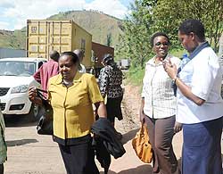 EALA MPs Odette Nyiramirimo (2nd right)  and Kate Kamba (L) talk to a clearing agent at the Rusumo border post on Monday. The New Times / John Mbanda.
