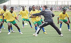 LEADING BY EXAMPLE: Amavubi Stars coach Sredejovic Milutin show his players how it is done during the team's last training session, on Wednesday, before departing to Eritrea. The New Times / Bonnie Mugabe