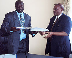The former Vice Rector (Academics) of KIE Dr. James Vuningoma (R), hands over to his successor, Prof. Wenceslas Nzabarirwa.The New Times / Grace Mugoya.
