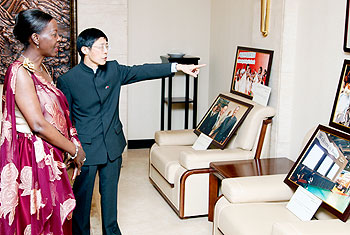 Chinese Ambassador to Rwanda Shu Zhan guides the Foreign Affairs Minister, Louise Mushikiwabo, to an art exhibition room.The New Times/ Timothy Kisambira.