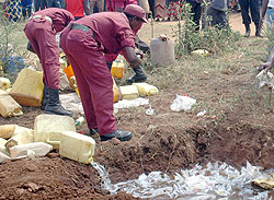 Members of the Local Defence Force distroying  illicit brew