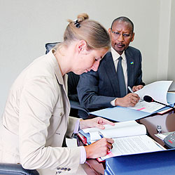 Dr. Daniela Beckmann the Director of Germany Development, ( L) together with Minister John Rwangombwa, signing a grant agreement yesterday. The New Times / Timothy Kisambira.