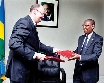 European Union Ambassador Michel Arrion (L) exchanges documents with John Rwangombwa, Minister of Finance on Tuesday after signing an Rwf 27billion agreement for Gatuna highway on Tuesday. The New Times/ Timothy Kisambira