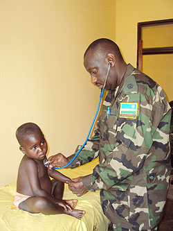An RDF paediatrician attends to one of the children at Gihara Health Centre. The New Times / D. Sabiiti.