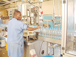 Workers in a Rwandan water bottling plant; Manufacturers have decried the high costs of production in the country.The New Times /  File.