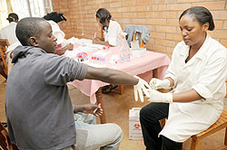 A patient takes an HIV test at a local health faciltity . RBC says over two million Rwandans test for the disease annually.