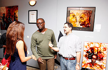 Kezio-Musoke David (C) chats with some of the guests at the event. The New Times / Timothy Kisambira.