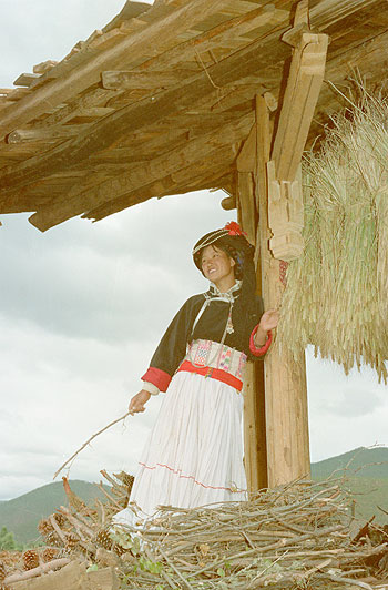 WAITING FOR HER MAN:  Zhuang Hama, a Mosuo girl, seems eagerly waiting for her boyfriend beside her motheru2019s wooden house at nightfall at Duoshe Village, Lugu Lake area, in China. The Mosuo community allows a girl, who is beyond puberty, to host and spend