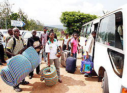  Students board a mini-bus as they head for Ingando, yesterday. Close to 40,000 will participate in the three-week exercise. The New Times /Timothy Kisambira